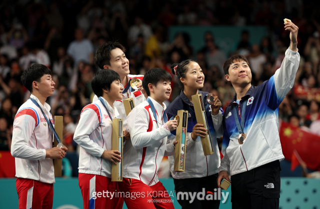 2024 파리올림픽 탁구 혼합복식 동메달을 목에 건 한국의 임종훈(오른쪽부터)과 신유빈이 7월 31일(한국시간) 시상식이 끝난 뒤 금메달을 딴 중국의 왕추친-쑨잉사 조, 은메달리스트인 북한의 김금용-이정식 조와 삼성 Z 플립6로 기념촬영을 하고 있다/게티이미지코리아