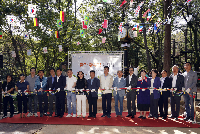 지난달 30일 관악산 신림계곡 산책로에서 열린 깨비증권 그린로드 개장식에서 강진두 KB증권 경영지원부문장 부사장(오른쪽에서 여섯번째)과 박준희 관악구청장(오른쪽에서 여덟번째), 박동창 맨발걷기국민운동본부 회장(오른쪽에서 일곱번째) 등 관계자들이 테이프 커팅식을 진행하며 기념사진을 촬영하고 있다./ KB증권